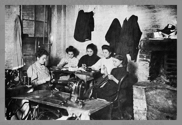 Five Immigrant Women Sit at a Table and Sew 1900