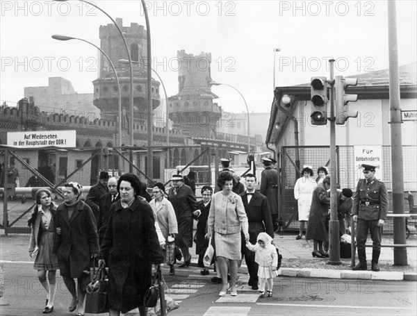 West german citizens passing through the oberbaum bridge checkpoint into east berlin in the gdr, april 7, 1966.