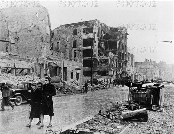 Berlin residents walk through the ruins of the city after the city was taken by the soviet red army, may 1945, world war 2.