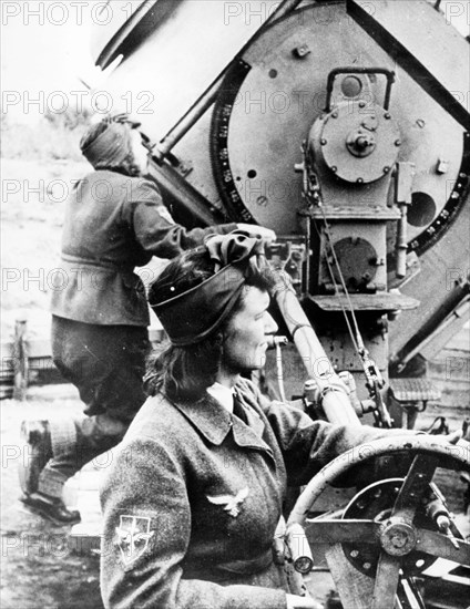 Women on exercises with spot lights at a fascist anti-aircraft post during world war ll, 1944.