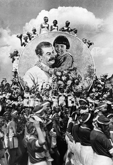 A young pioneers sports festival in 1937, in the background is an image of joseph stalin with engelsina (gelya) markizova.