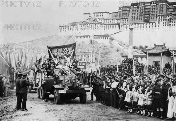 Chinese people's republic invasion of tibet, 1954, the chinese authority stage a parade in lhasa, december 25th, 1954, potala palace (home of the dalai lama) in the background.