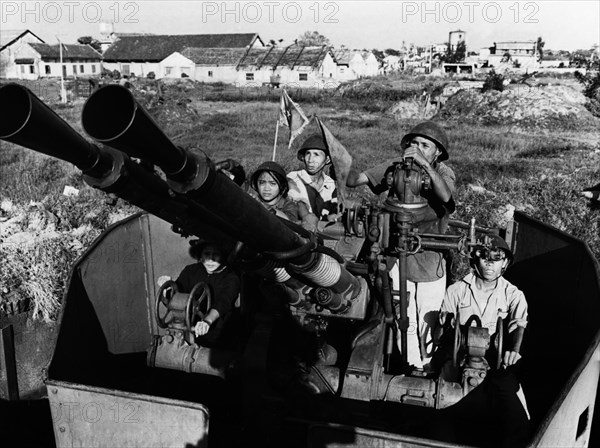 Members of the bach dang shipyards militia with their anti-aircraft gun, defending their workplace against american air attack, north vietnam, 1969.