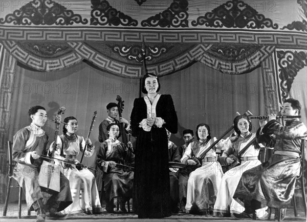 Mongolian singer tsogzolma performs a traditional mongolian song accompanied by the mongolian folk instruments ensemble, mongolia, january 1950.