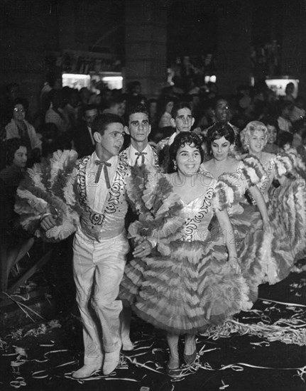 Young men and women dancing the comparsa, one of the most popular folk dances in cuba, during carnival, a traditional national festival, 1962.
