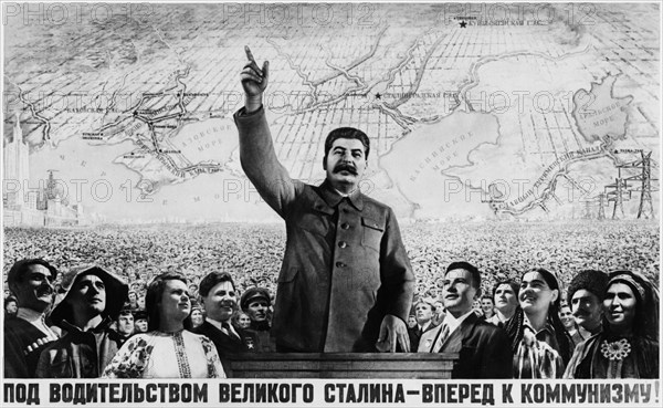 A soviet propaganda poster featuring joseph stalin published by the iskusstvo publishing house, 1950 (?), 'under the leadership of great stalin - forward to communism'.