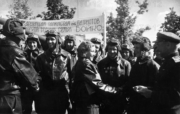 The boiko's tank unit receives new js-122 (joseph stalin 122) heavy tanks, 1942, tank commander,  junior lieutenant alexandra boiko and her husband, driver/mechanic ivan boiko being welcomed by their new comrades.