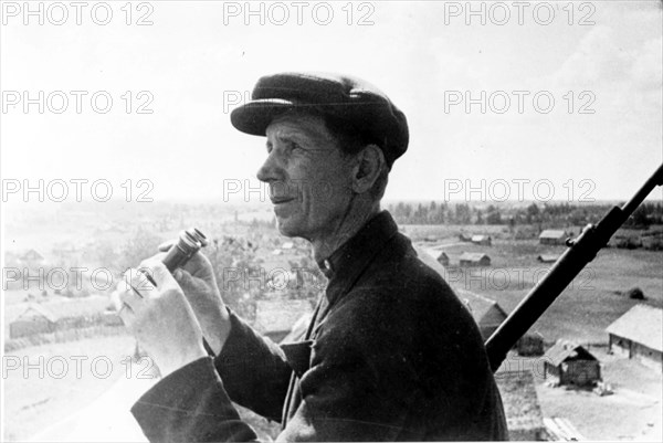 Soviet collective farmer on watch for nazi airplanes.