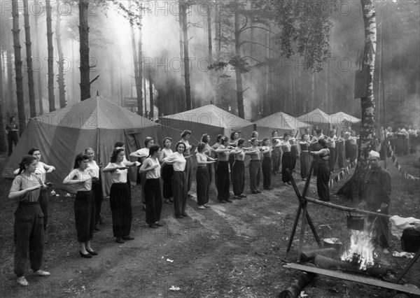 Soviet health spa, a group of women doing their morning exercises at a camp in the moscow region, june 1953.