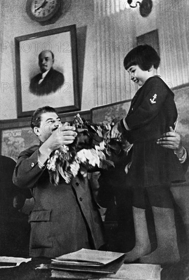 Joseph stalin receiving a bouquet of flowers from engelsina (gelya) markizova, the 7-year-old daughter of the second secretary of the buryat-mongolian regional party committee in 1936, stalin had him executed the following year, her mother was arrested and exiled to kazakhstan where she died under suspicious circumstances in 1940.