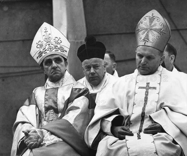 Cardinal karol wojtyla (later pope john paul 2) archbishop of cracow, poland (right), left: archbishop adam kozlowiecki from zambia, at eremonies to commemorate 25th anniversary of liberation of dachau concentration camp, kalisz, poland, 1970.