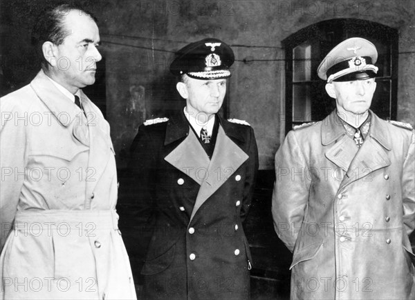 Albert speer (l), hitler's minister of production, grand admiral doenitz and general jodl, seen after their arrest in a courtyard at flemsburg, seat of doenitz government, 1945.