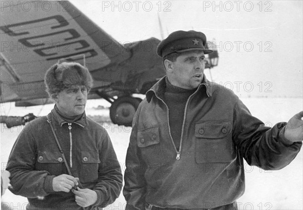 Hero of the soviet union m,v, vodopyanov, commander of the flagship plane ussr n-170, and chief navigator of the expedition maj, i,t, spirin, at the airdrome in kholmogory on the way to rudolf island, (credit: sovfoto/eastfoto).