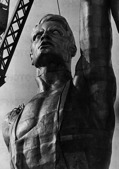 Worker figure being assembled out of stainless steel as part of a giant statue designed by v,i, mukhin also featuring a collective farm girl, the statue is being built for the soviet pavillion at the world exposition in paris, 1937.