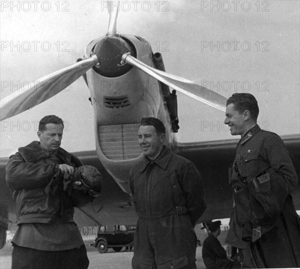 The crew of the ant 25-1, second plane to make a transpolar nonstop flight from the ussr to the usa in the summer of 1937, shown at the schelkovo airdrome near moscow, in front of their plane are (l to r): mikhail gromov, commander, s,a, danilin, navigator, and a,b, yumashev, second pilot,  (credit: sovfoto/eastfoto).