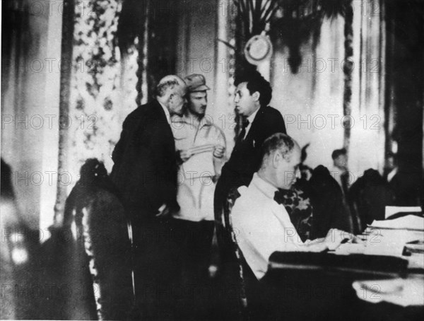 Left to right, standing: v,i, lenin, nikolai bukharin and grigory zinoviev talking during the 2nd congress of the communist international, 1920, moscow, soviet union.