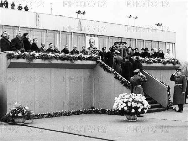 The crews of the soyuz 6, soyuz 7 and soyuz 8 space missions arrive at vnukovo airport in moscow on october 22, 1969, they reporting to the heads of the ussr government, leonid brezhnev is standing by the portrait of lenin.