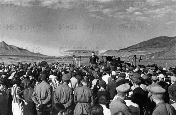 Preparations for the elections to the supreme soviet of the azerbaijan ssr, a meeting in stepanakert in the nagorno-karabakh autonomous region upon the arrival of a propaganda airplane, june 1938, the plane is a polikarpov po-2 (u-2).