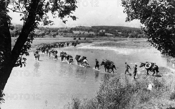 The 'x' mountain pack 107mm mortar regiment crossing a river in the foothills of the carpathians, july 1944, world war ll.