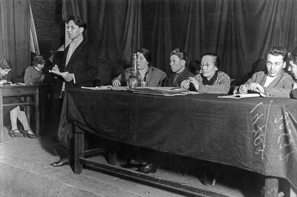 Rozaliya zemlyachka (seated with glasses) during a purge trial at a co-operative in moscow, 1933, a leading bolshevik party member, she was one of the organizers of the 'red terror' during the civil war, she was responsible for the execution of thousands of white guard officers in the crimea after it was occupied by the red army in 1921.
