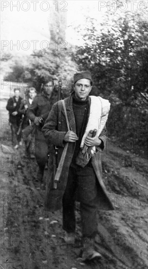 World war 2, december 1944, the yugoslavian national liberation army receives replenishments from the towns and villages liberated from the german fascist invaders, these volunteers, armed with captured enemy arms, on their way to the enlistment station.
