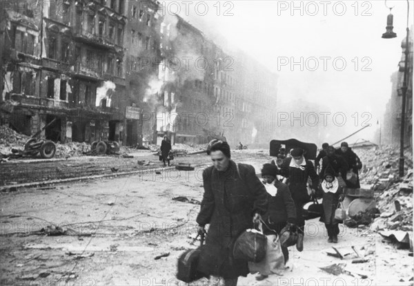 German civilians fleeing berlin under the red army attack, world war 2, city in ruins, 1945.