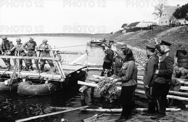 Soviet red army troops meeting the troops of the 1st american army as they cross the elba river near torgau, germany on april 25, 1945.