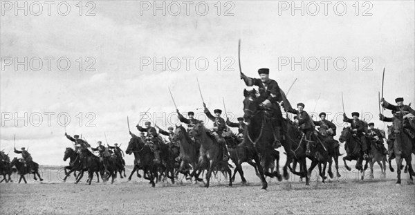 A cossack cavalry unit charging with sabres drawn on the crimean front, may 1942.