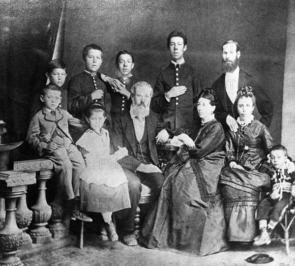 Chekhov family portrait, in the center, sitting, are the parents,pavel and yevgenia chekhov, on the left are mikhail and maria, on the right is aunt lyudmila with her son georgy, standing (from left) are ivan, anton, nikolai, alexander, and uncle mitrofan, 1874 or 1875.