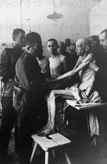 A soviet army surgeon examines an auschwitz concentration camp survivor, vienna engineer rudolf scherm, auschwitz, poland, february 1945.