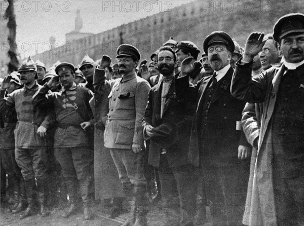 A parade in red square, moscow, soviet union, may 1st, 1922, left to right: mikhail lashevich (second from left), leon trotsky (center, military uniform, beard), lev kamenev (second from right), tomsky (far right).