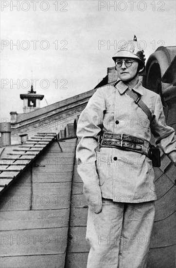 Composer dmitri shostakovich, member of the volunteer fire fighting squad of the leningrad conservatory, during a drill during world war ll.