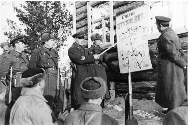 world war ll: soviet army men and commanders studying a plan for attack on an enemy iron and concrete fort.