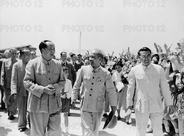 President ho chi minh of the democratic republic of vietnam being met at the airport by chairman mao zedong upon his arrival in peking (beijing), china on june 25, 1955.