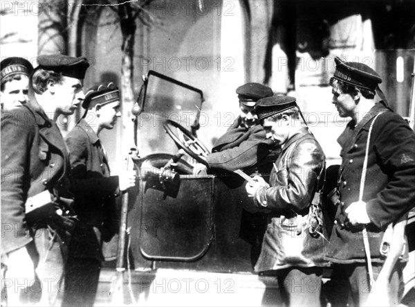 A naval patrol checking documents on the streets of petrograd ( st, petersburg ) in october of 1917.