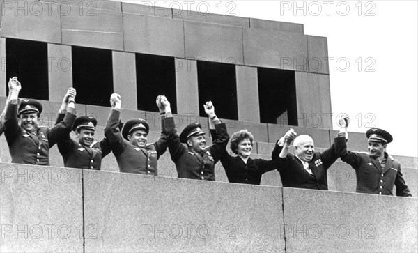 Soviet cosmonauts (left to right) dozovich, titov, andreyevich, gagarin, tereshkova, and bykovsky on lenin's tomb with nikita khrushchev, moscow, ussr, 1963.