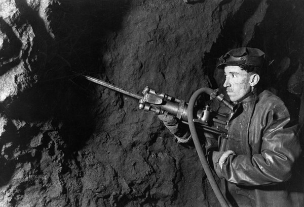 Chapai sozayev working in a mine in the 'krasnaya shapochka' (red riding hood) bauxite bed in the northern urals, ussr, 1947.