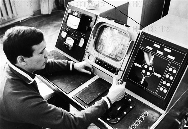 Luna 21 mission, an operator preparing the equipment for communication traffic, working at the controls of the soviet remote-controlled lunar rover, lunokhod 2 at the distant space communications center,  january 1973.