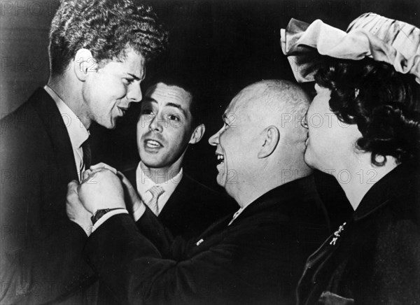 Nikita khrushchev congratulating van cliburn for winning the first prize during the closing ceremonies of the tchaikovsky international violin and piano competition, april 14, 1958, us ambassador thompson's wife is on the right.
