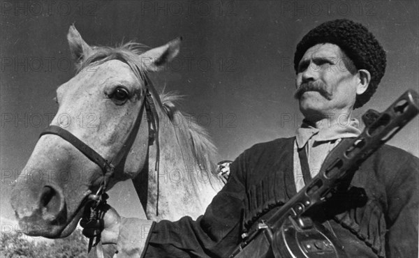 60 year old cossack pavel kamnev of the guards corps commanded by lieutenant-general kirichenko, kamnev, together with his two sons, volunteered to fight the hitlerite invaders, in an engagement near the village of kushchanskaye, he sabered 14 germans, he has been awarded the order of lenin for his valor, northern caucasus, october 1942.
