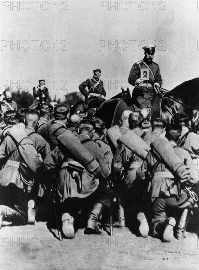 Tsar nicholas ll, on horseback holding an icon, during prayers before a battle at the front in world war i.