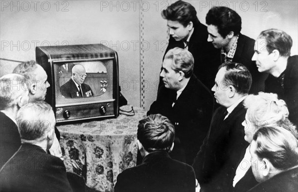 Workers of the state bearing plant no, 1 in moscow, watching nikita khrushchev give a report at the ussr supreme soviet on the present day international situation and the foreign policy of the soviet union on a tv set at the factory's house of culture.