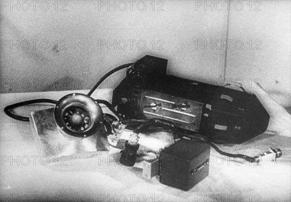 A photo electric device and multiplier controlling the use of batteries used in sputnik 2, the larger device is the other radio transmitter, while the satellite was in the shadow of the earth, electric current was cut off to economise the heavy drain on the batteries and switched on again when the satellite emerged into the sunlight, 1957.