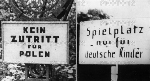 World war 2, signs put up by the germans in the public places of warsaw, sign on the left reads: entrance to poles forbidden, sign on the right reads: playground for german children only, august 1941.