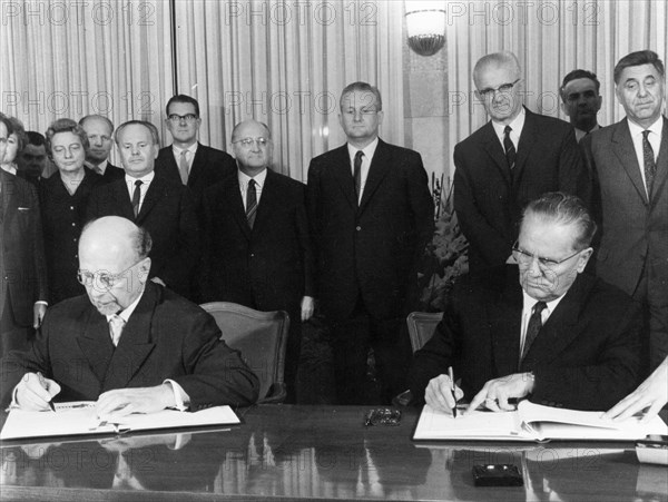 Walter ulbricht of the gdr and josip broz tito, president of the socialist federal republic of yugoslavia and secretary general of the league of communists signing a joint statement on october 1, 1966, the signing occurred after their talks in which both parties agreed to elevate their diplomatic representations to embassies.
