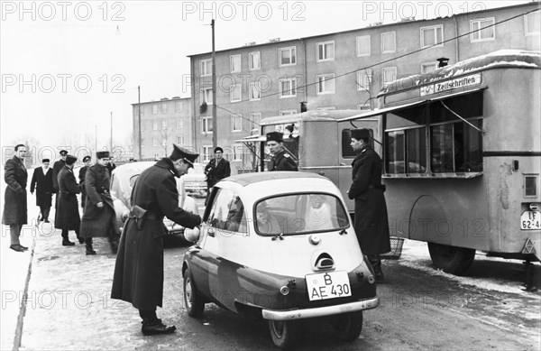 The first west berliners crossing over at the sonnenallee checkpoint to visit relatives in east berlin in accordance with a recently signed treaty allowing such visits, december 1963.