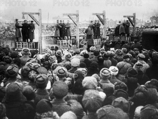 World war 2, december 19, 1943, still from a film on the kharkov trial produced by artkino, long shot of the execution, a truck was driven under the gallows, a chair placed on it, and the criminal on the chair.