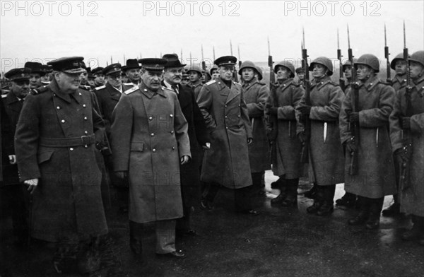 Moscow conference, winston churchill, stalin, and molotov passing an honor guard prior to the departure of the british delegation.