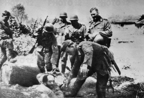 World war 2, german soldiers having fun tormenting a ukrainian jew, 1941, the photo was taken by a german soldier captured by the red army.