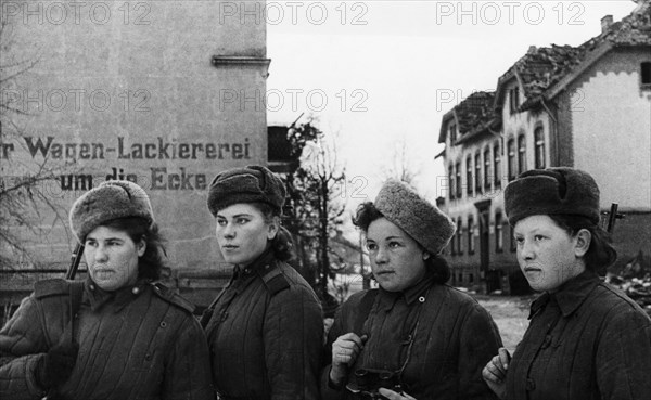 Third belorussian front, world war 2, a group of young women, red army snipers who have 2,000 german kills between them, inspecting a small town in east prussia that has been taken by the soviet army, february 1945.